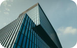 Glass office tower against a blue sky