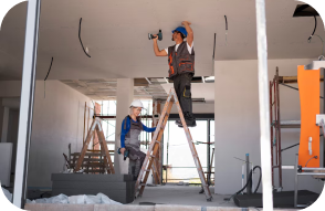 Workers installing ceiling fittings during an interior renovation
