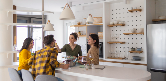 Coworking members chatting around a shared kitchen counter