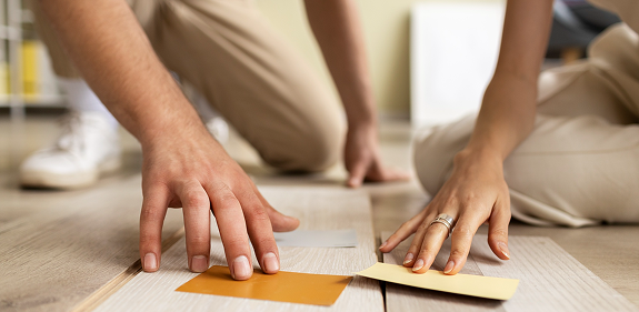 Comparing timber flooring samples on site