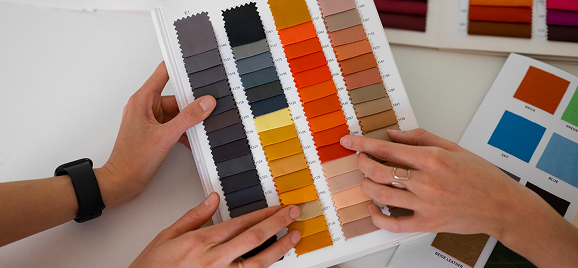 Choosing upholstery fabric from a colour swatch book