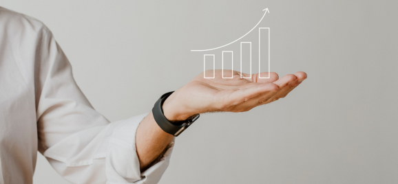 Hand presenting a business growth chart