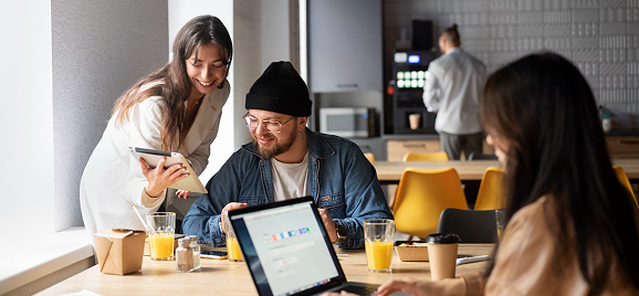 Colleagues collaborating in a modern office breakout area