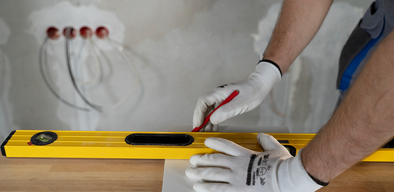 Contractor checking a wall with a spirit level